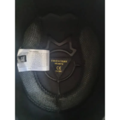 equestrian helmet front view with visor and metal element