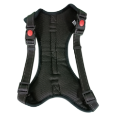 Dog harness in size XL packaged in plastic on a green background with a measuring tape